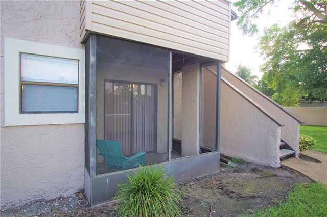 doorway to property with stucco siding