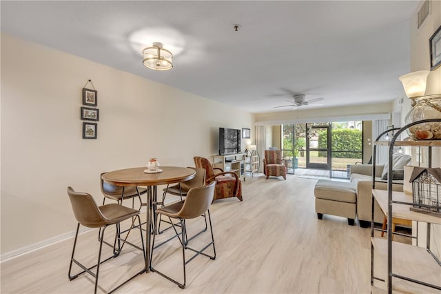 445 Bouchelle Dr Unit 104, New Smyrna Beach, FL 32169 - dining room with light wood-type flooring and ceiling fan