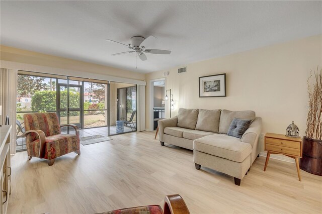 445 Bouchelle Dr Unit 104, New Smyrna Beach, FL 32169 - living room featuring a ceiling fan and light wood-style flooring