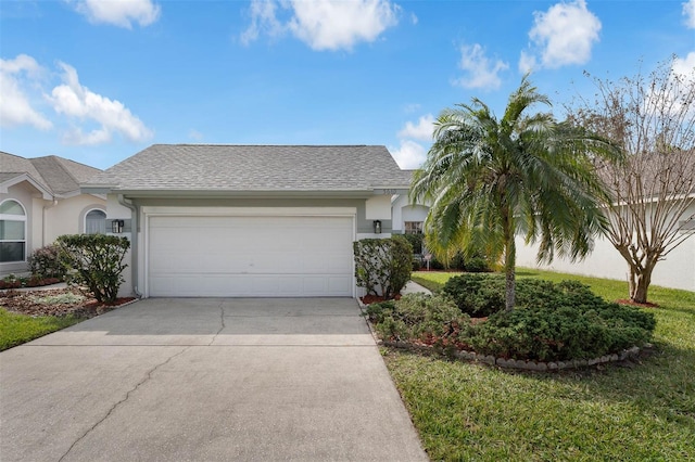 single story home featuring roof with shingles, an attached garage, driveway, and stucco siding