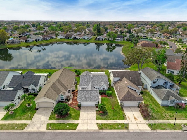 birds eye view of property featuring a residential view and a water view