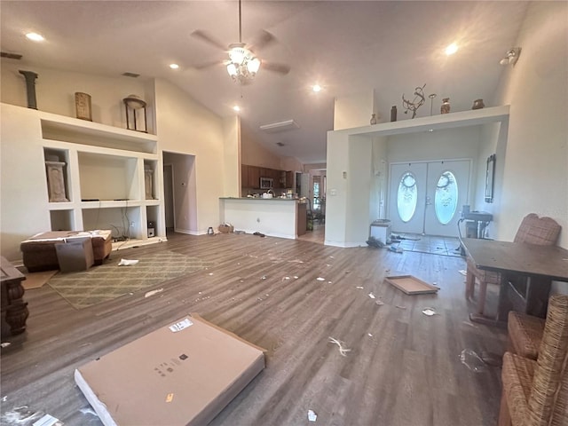 living room with a ceiling fan, wood finished floors, visible vents, high vaulted ceiling, and french doors