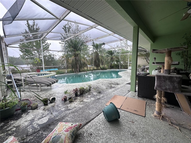 outdoor pool featuring glass enclosure and a patio