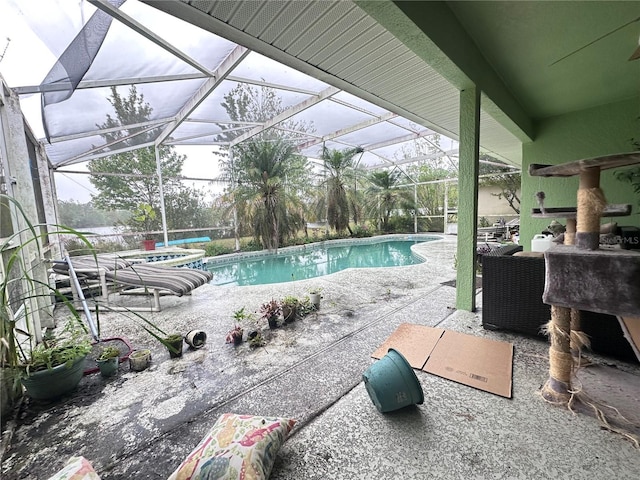 outdoor pool with a lanai and a patio area