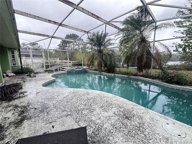 view of pool featuring a patio, a lanai, and a pool with connected hot tub