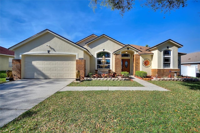 view of front of home with a front lawn, brick siding, an attached garage, and driveway