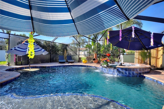 pool featuring a lanai, a jacuzzi, and fence