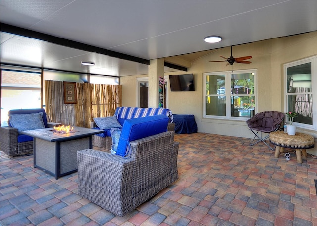 view of patio / terrace featuring an outdoor living space with a fire pit and a ceiling fan