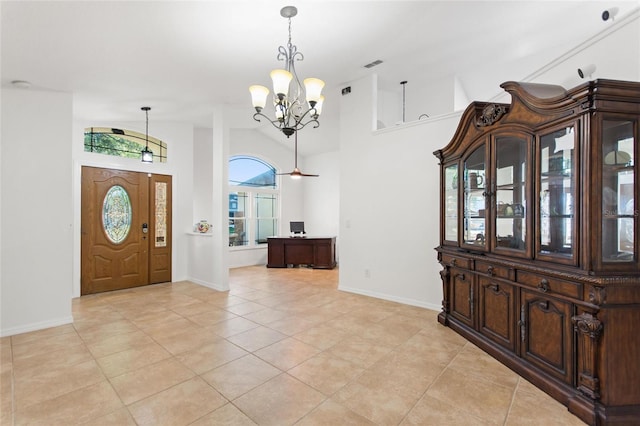 entryway with baseboards, visible vents, high vaulted ceiling, an inviting chandelier, and light tile patterned flooring