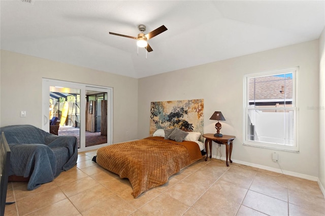 bedroom with light tile patterned floors, ceiling fan, baseboards, and vaulted ceiling