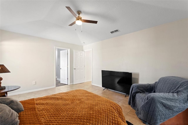 bedroom with vaulted ceiling, light tile patterned flooring, baseboards, and visible vents