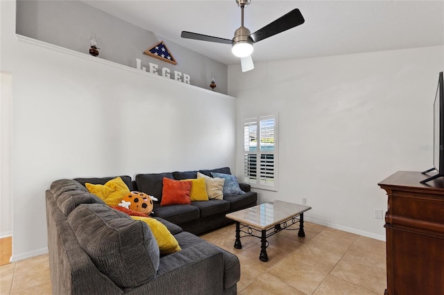 living area with light tile patterned floors, baseboards, and ceiling fan