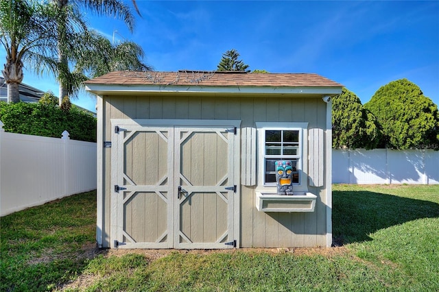 view of shed with a fenced backyard