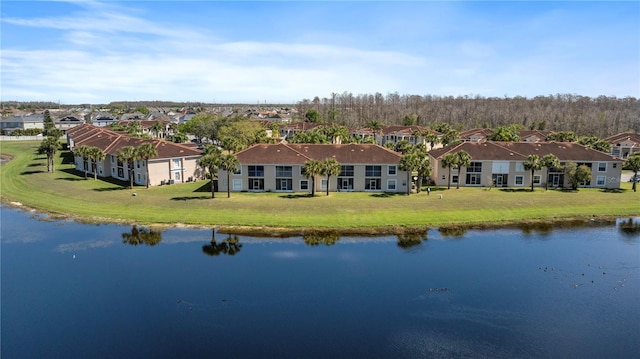 drone / aerial view with a residential view and a water view