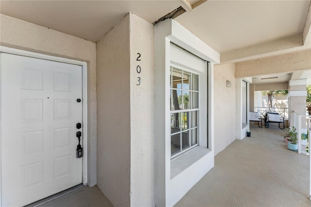 doorway to property with stucco siding