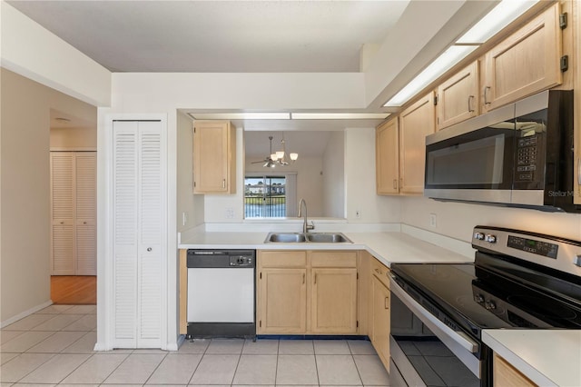 kitchen featuring a sink, stainless steel appliances, light brown cabinetry, and light countertops