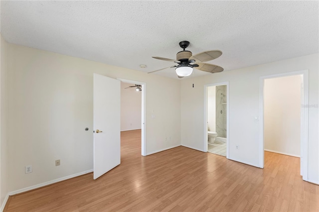 unfurnished bedroom with a ceiling fan, baseboards, light wood finished floors, and a textured ceiling