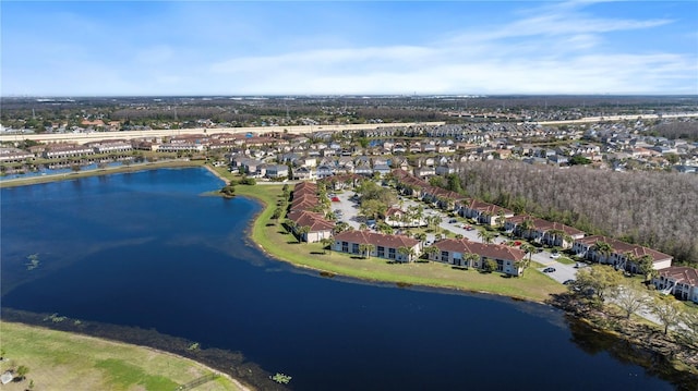 drone / aerial view featuring a residential view and a water view