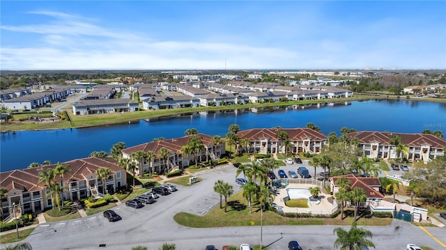 drone / aerial view featuring a residential view and a water view