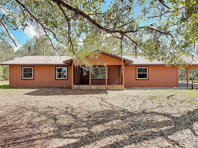 rear view of property featuring metal roof