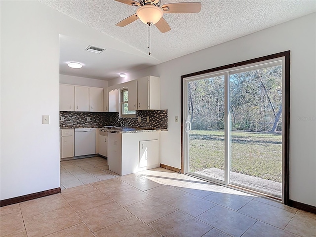 kitchen featuring visible vents, backsplash, white cabinets, white dishwasher, and light tile patterned floors