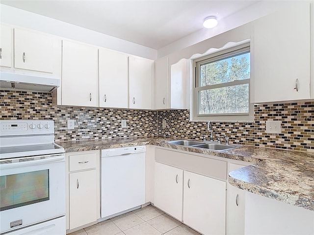 kitchen featuring white appliances, backsplash, under cabinet range hood, and a sink