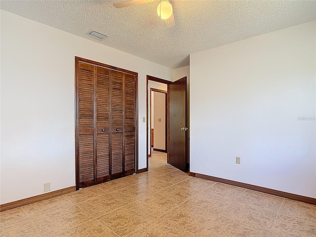 unfurnished bedroom featuring a ceiling fan, baseboards, visible vents, a closet, and a textured ceiling