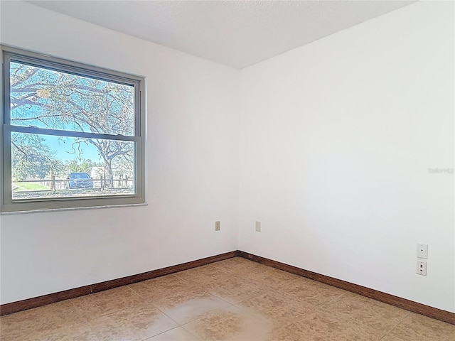 unfurnished room featuring baseboards