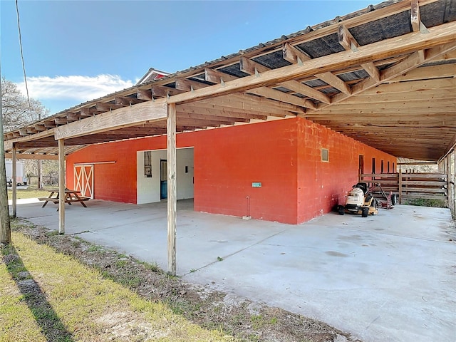 view of side of property featuring an exterior structure, an outbuilding, and a carport