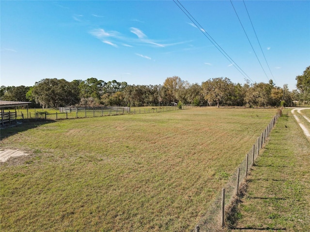 view of yard with a rural view and fence