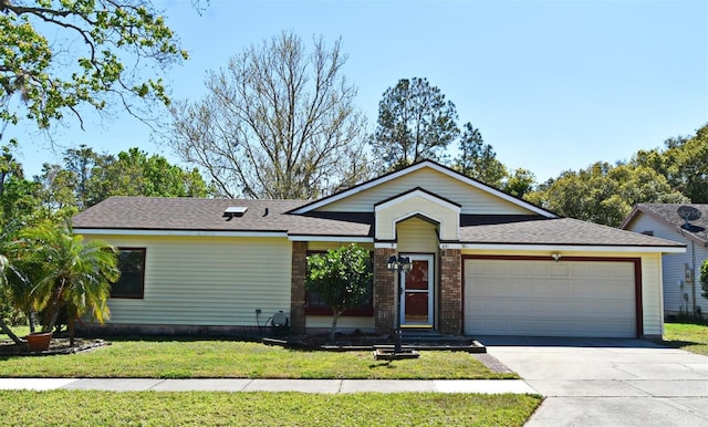 view of front of house with brick siding, concrete driveway, roof with shingles, a front yard, and a garage