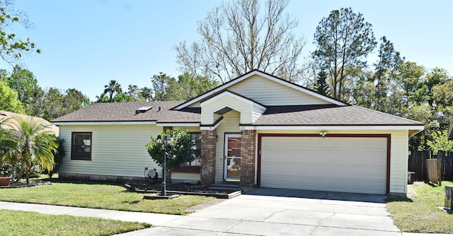 ranch-style home with brick siding, a front lawn, fence, concrete driveway, and an attached garage