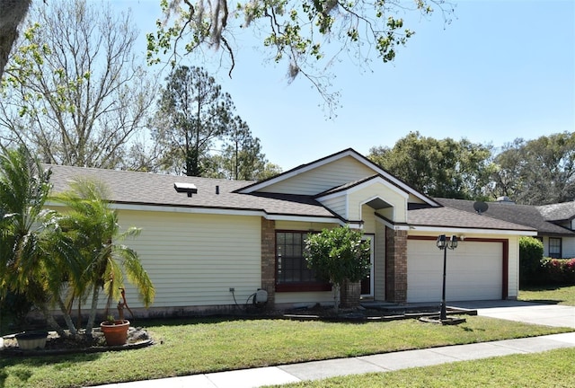 ranch-style house featuring a front yard, roof with shingles, an attached garage, concrete driveway, and brick siding