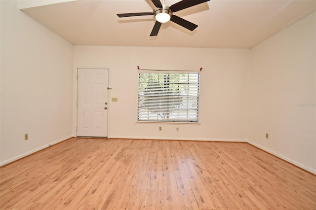 spare room with a ceiling fan, baseboards, and light wood finished floors