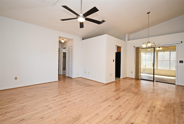 empty room featuring light wood finished floors, visible vents, baseboards, vaulted ceiling, and ceiling fan with notable chandelier