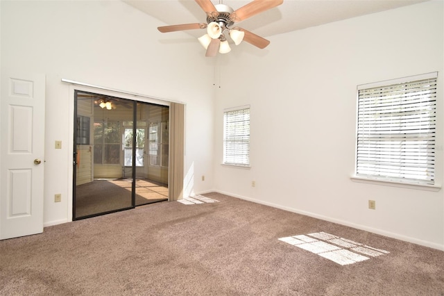 unfurnished room featuring carpet flooring, a ceiling fan, and baseboards