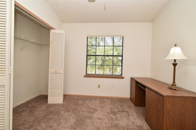 unfurnished bedroom featuring a closet, baseboards, carpet, and a textured ceiling