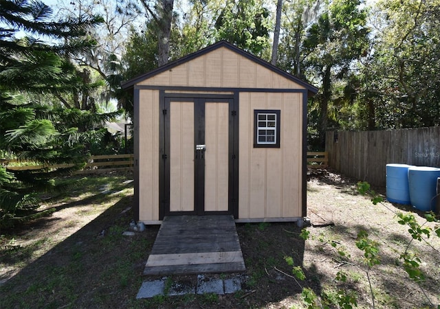 view of shed with fence