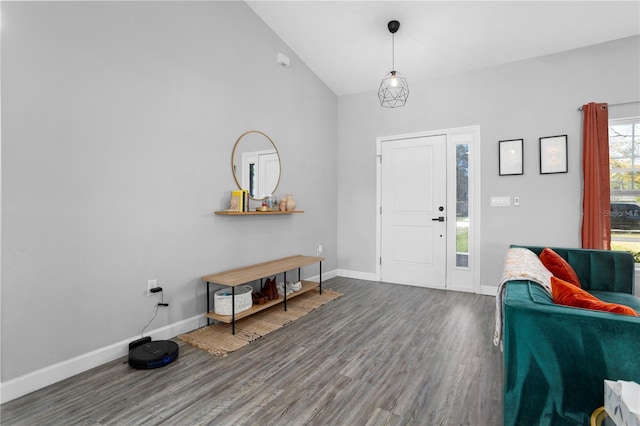 foyer entrance featuring lofted ceiling, baseboards, and wood finished floors