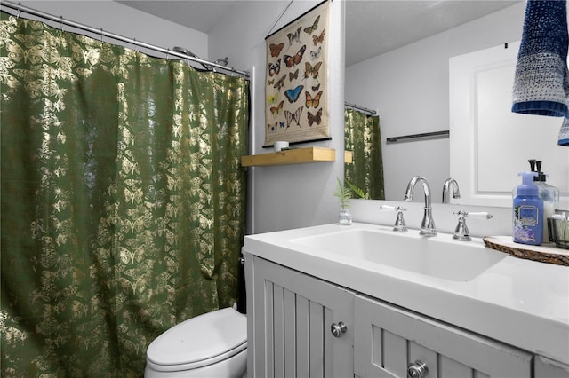 bathroom featuring toilet and vanity