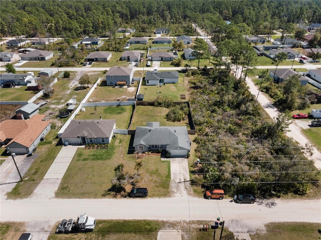 drone / aerial view with a forest view and a residential view