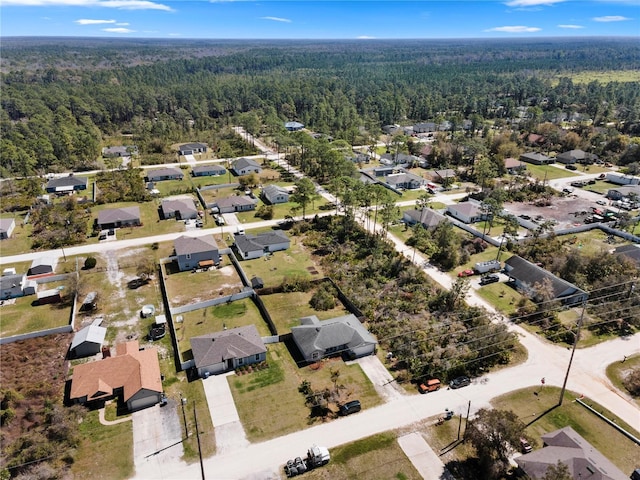 aerial view featuring a view of trees and a residential view