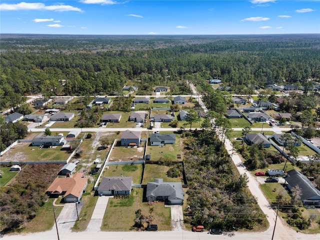 birds eye view of property with a forest view and a residential view