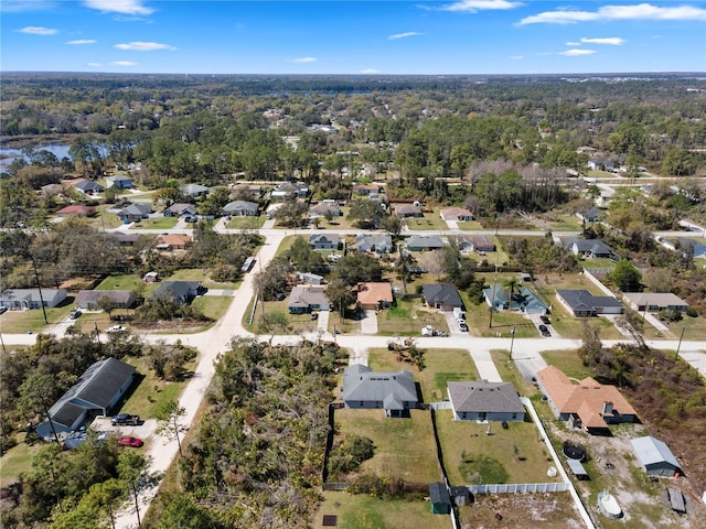 drone / aerial view with a forest view and a residential view