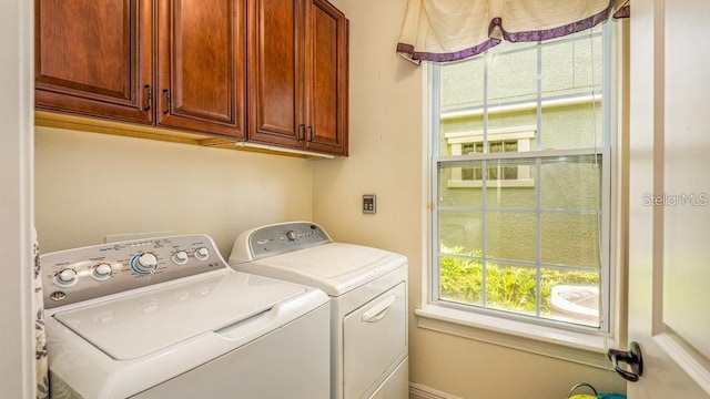 laundry area featuring cabinet space and washer and clothes dryer