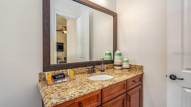 bathroom featuring vanity and a textured wall