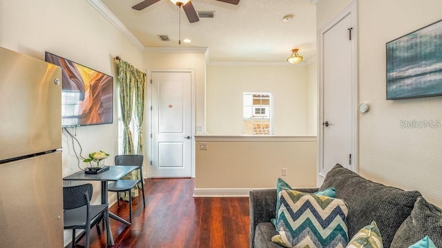 sitting room featuring visible vents, crown molding, ceiling fan, and wood finished floors