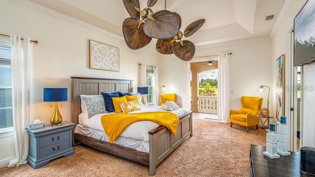 bedroom featuring visible vents, a tray ceiling, access to exterior, light carpet, and crown molding