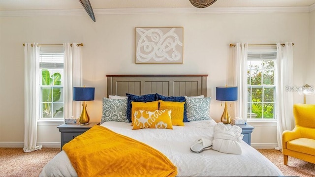 carpeted bedroom featuring baseboards and ornamental molding