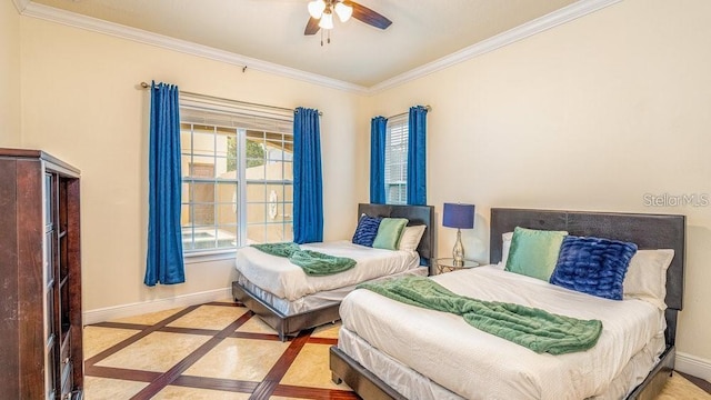 bedroom featuring a ceiling fan, baseboards, and ornamental molding